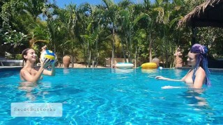 Naked teens play with a ball in the pool